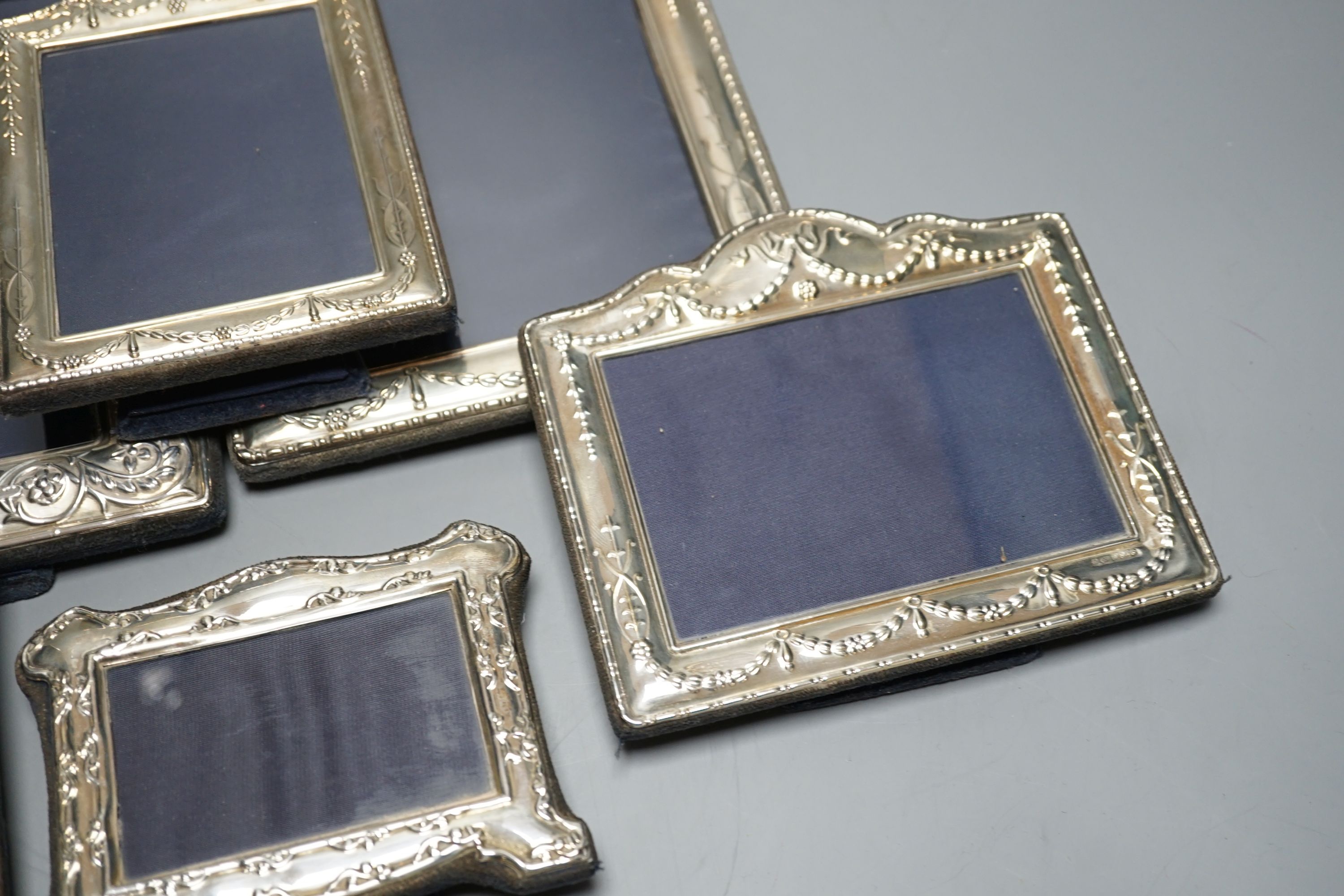 Two modern graduated pairs of decorated silver mounted photograph frames, Carrs of Sheffield, 2000 & 2001, largest 25.6cm and two smaller silver mounted frames.